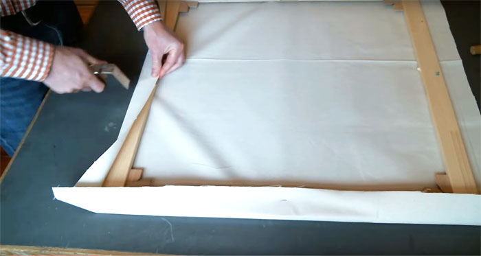 Stretching canvas on a stretcher frame
